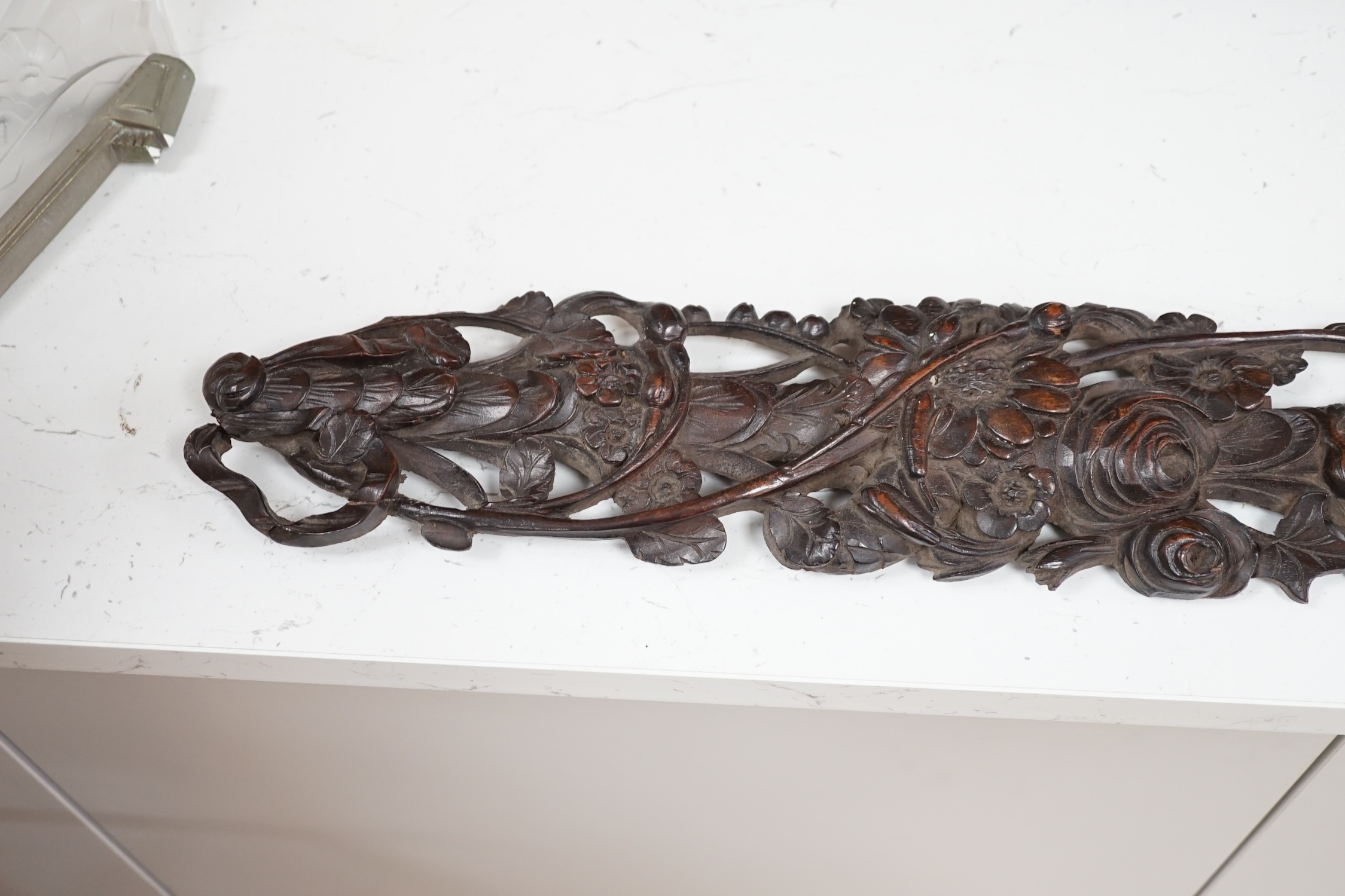 A carved walnut frieze and section with floral decoration, 131cm long. Condition - poor to fair, broken into sections and some woodworm